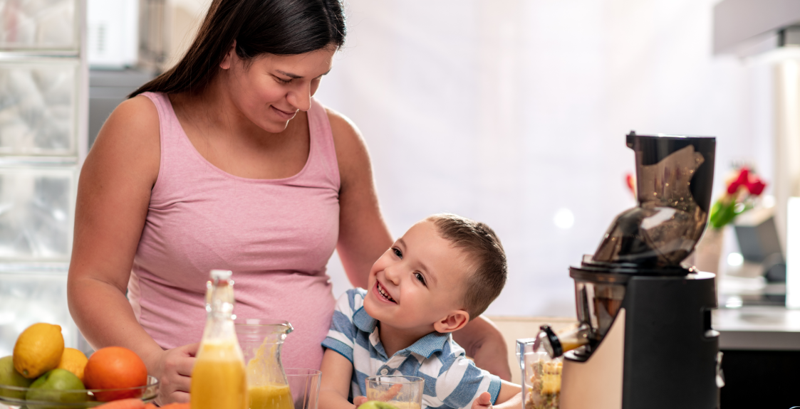 A pregnant person prepares food in a home kitchen to help prevent anemia during pregnancy.